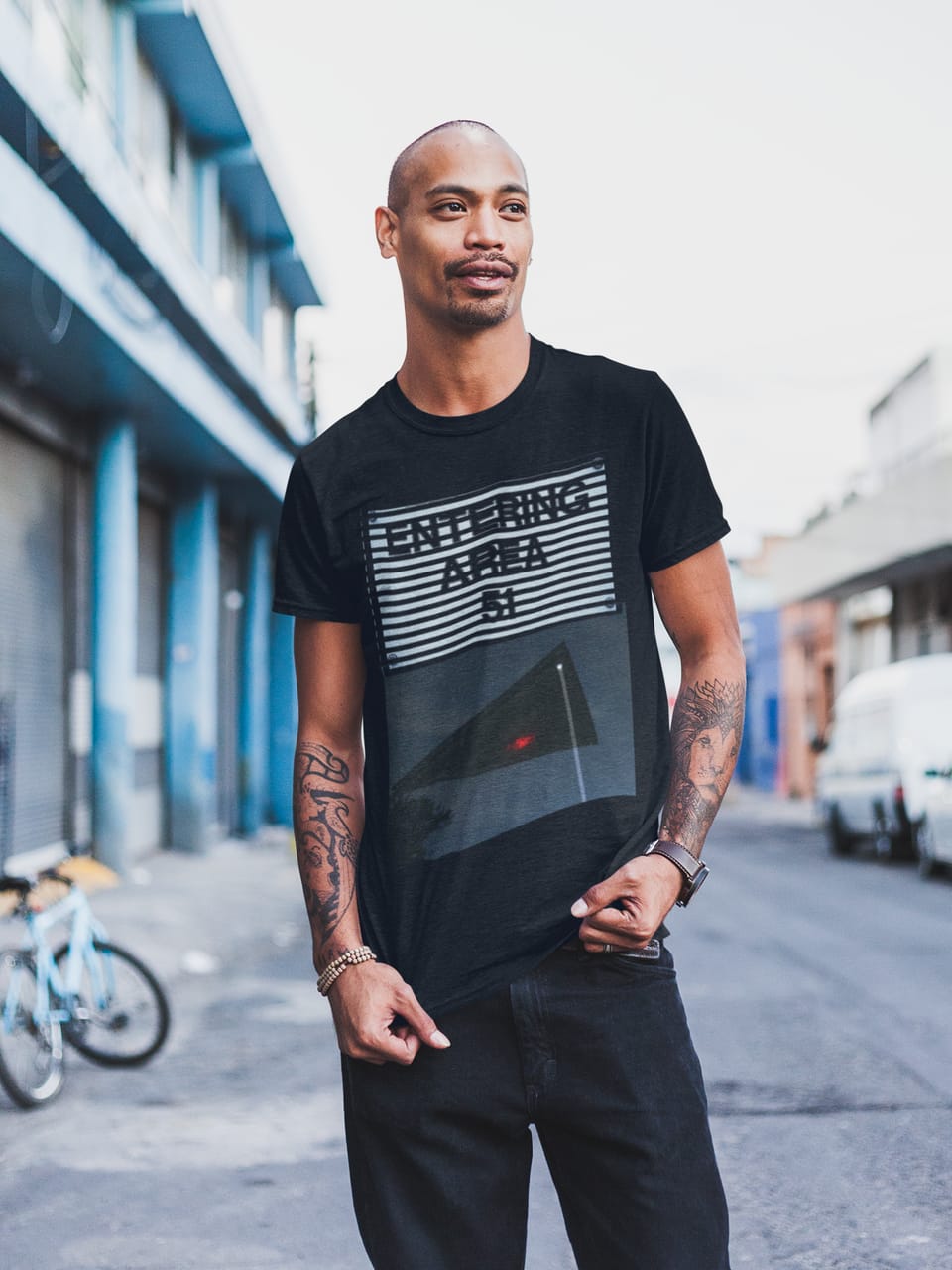 Model on a city street wearing the Area 51 Black Triangle “Entering Area 51” tee