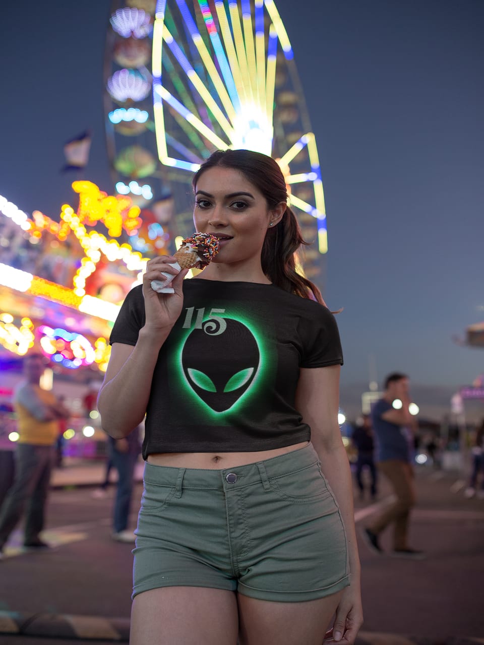 Model at a night fair wearing the black Element 115 Glowing Alien Grey tee