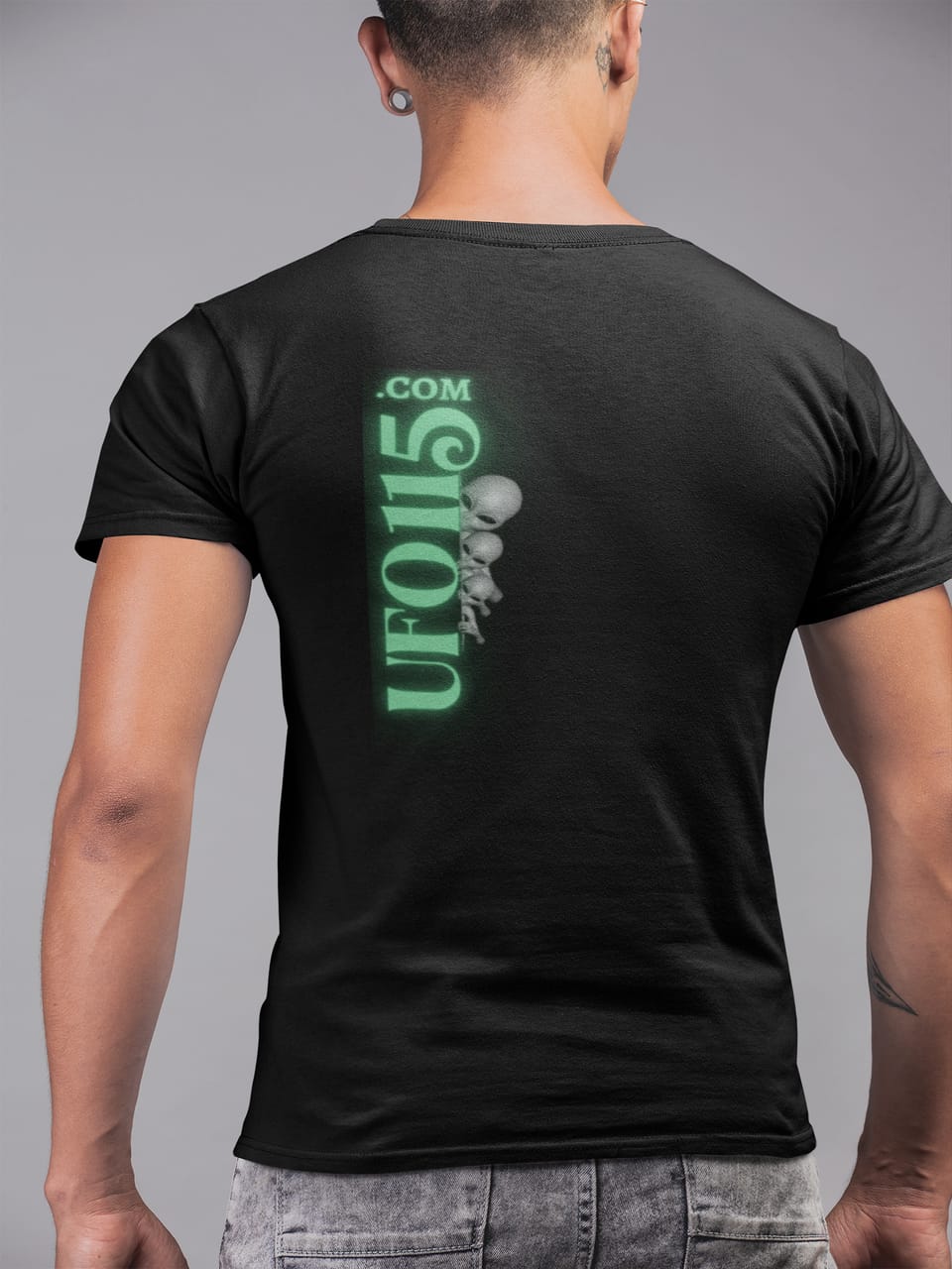 Model wearing the black UFO115 Green Angel tee with the green wordmark