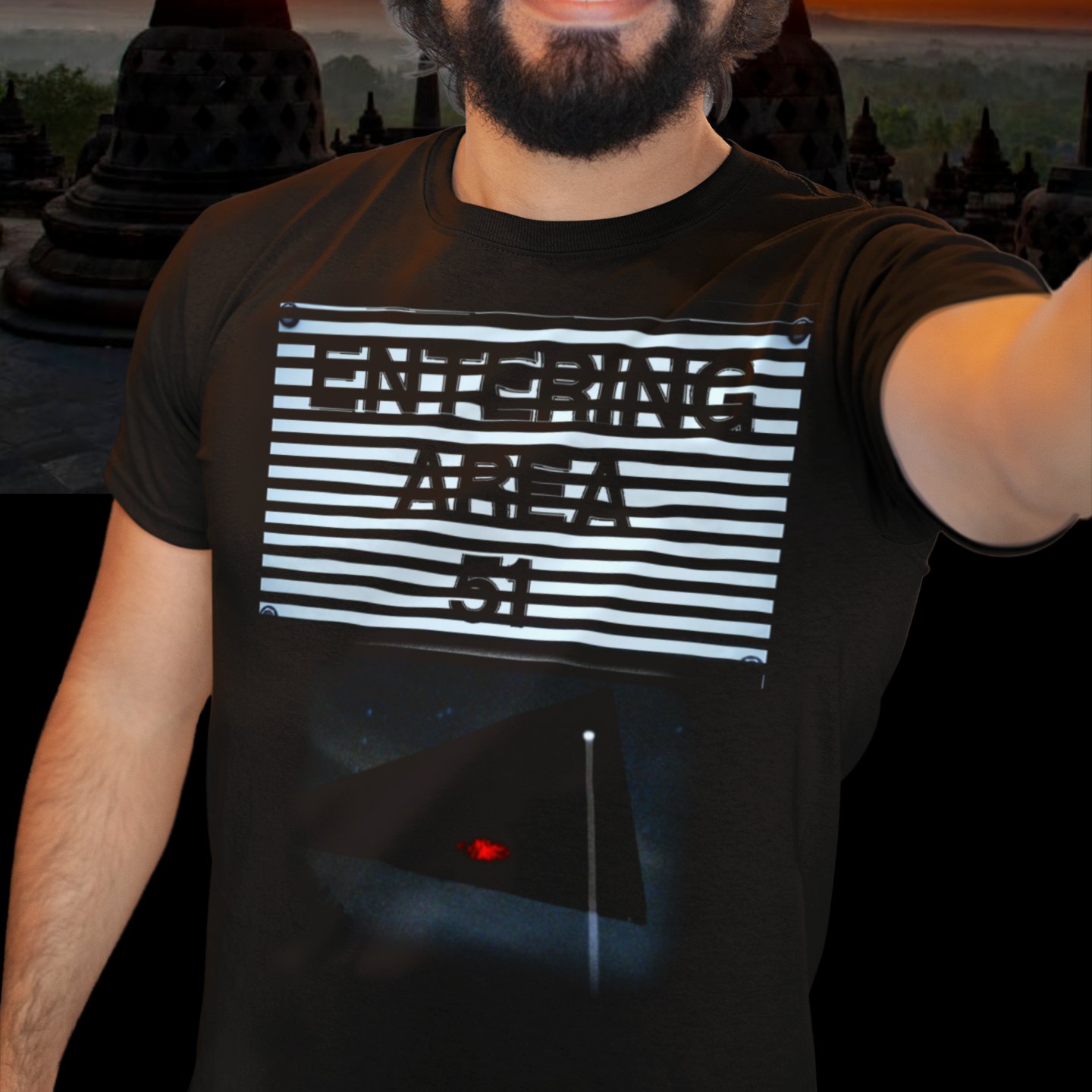 Area 51 – Black Triangle T-shirt in Black, front print, worn by a model (temple at sunset). AI-edited photo: the real print artwork was digitally placed on a model photo.